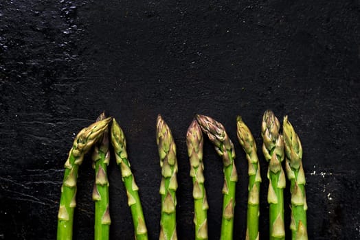 Fresh green asparagus on rustic black board