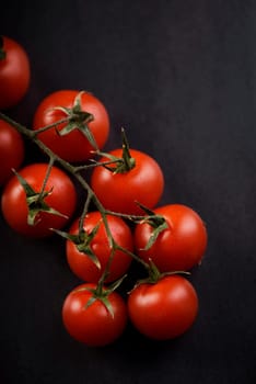Cherry tomato on rustic black background