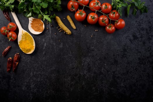 Food ingredients and various spices on black rustic background