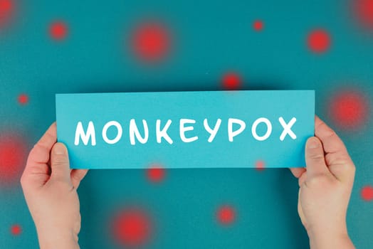 The word monkeypox is standing on a paper, outbreak of the MPXV virus, infectious disease spreading