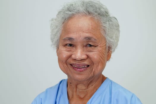 Asian elder senior woman patient sitting and smile face with happy on bed in hospital.