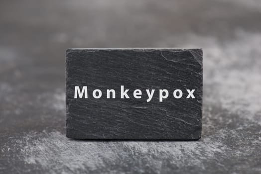 The word monkeypox is standing on a board, outbreak of the MPXV virus pandemic, infectious disease spreading