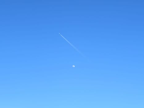 beautiful photo of the moon with plane crossing travel