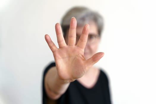 An adult woman protects herself with defensive hand movement