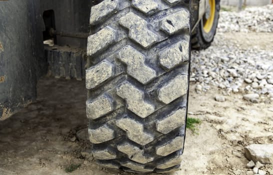 Detail of large rubber wheel of industrial vehicle
