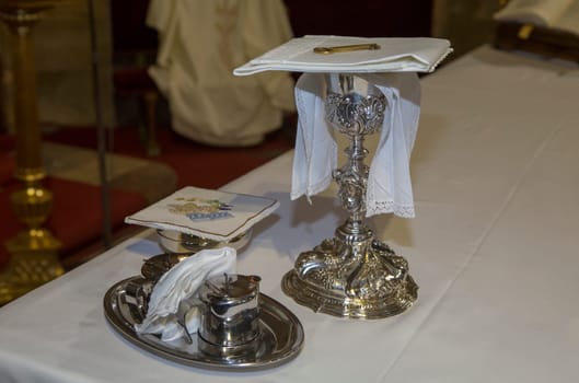 Plasencia, Spain - May 21h, 2022: Chalice, wine, water pitcher and pyx at Saint Nicholas Church, Plasencia, Caceres, Extremadura, Spain