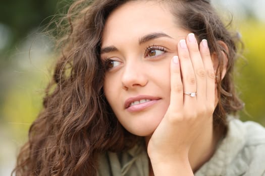 Woman showing engagement ring after proposal