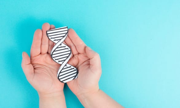Holding a DNA strand in the hand, genetic therapy and treatment, biotechnology in mordern medicine, gene-based vaccination health care