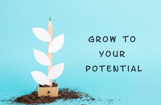 Plant made from a pencil and paper, the phrase grow to your potential is standing on the background, motivation, education and business concept