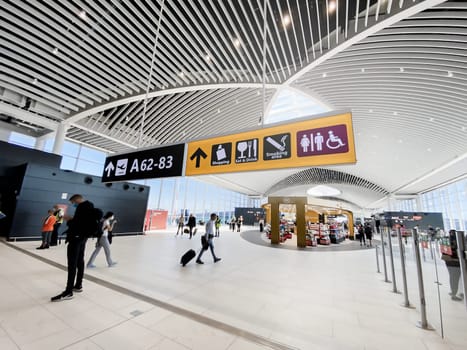 Rome, Italy, May 2022: People walking in the new departure hall of Leonardo Da Vinci Airport in Fiumicino, Rome