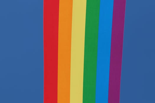 Rainbow backgrounds fabric. Closeup of rainbow linen canvas with colorful textured prallel vertical lines fabric macro. Outdoor LGBT background image.