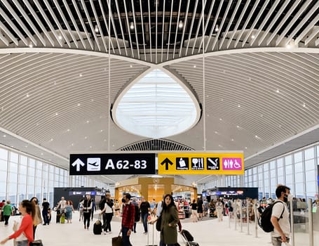 Rome, Italy, May 2022: People walking in the new departure hall of Leonardo Da Vinci Airport in Fiumicino, Rome