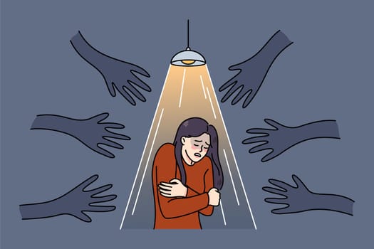 Terrified woman stand under spotlight haunted by numerous black hands. Unhappy scared girl suffer from psychological problems, have fears and anxiety. Vector illustration.