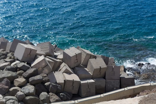 View of concrete breakwater from in a rock in Puerto Rico, Gran Canaria