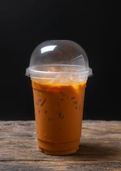 Tea thai, Ice tea milk or Ice milk tea, Sweet drink, Blurred black background