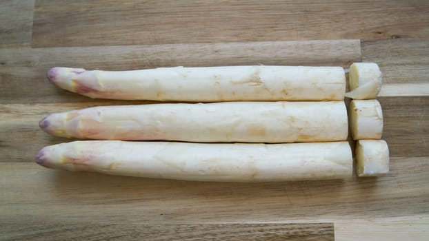 fresh asparagus with cut ends on a table in the kitchen