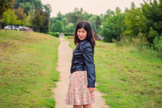 portrait of a young black-haired girl in the park