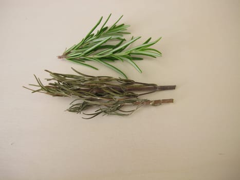 Fresh and dried rosemary on a wooden board