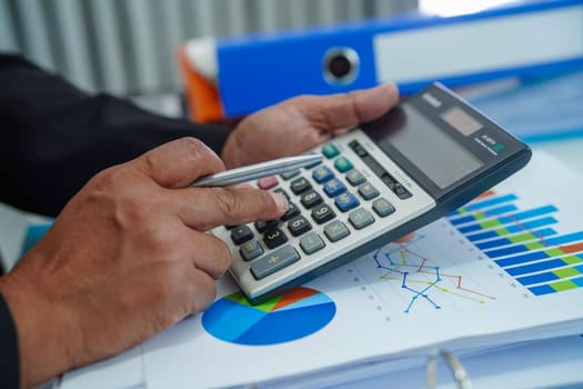 Businessman working and analysis with statistic graph in office.