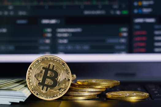 Bitcoins coin and banknotes on keyboard computer. Close up of  bitcoin crypto currency coins
