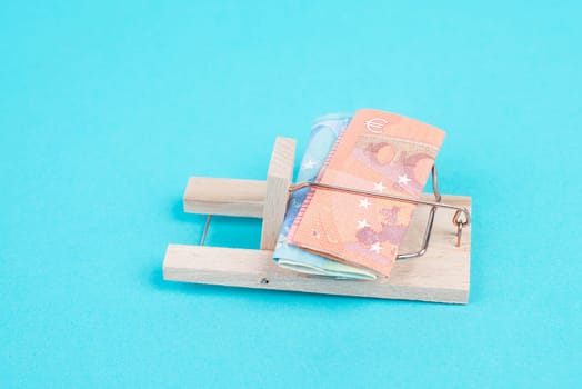 Euro banknotes in a mousetrap, bank loan, finanicial debt, inflation, risky credit and investment