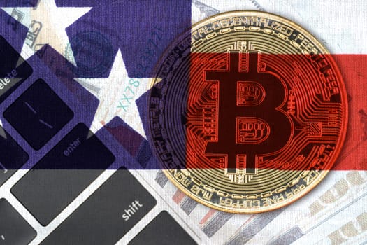 Golden Bitcoins coin and  US banknotes and keyboard computer. Close up of metal shiny bitcoin crypto currency coins and US dollar flag