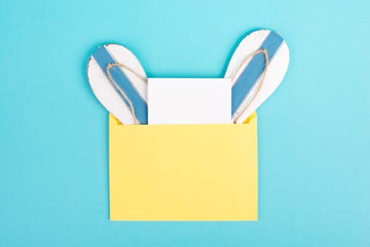 Blue colored summer and vacation background, flip flops in an envelope, copy space for text, holiday and tourism concept