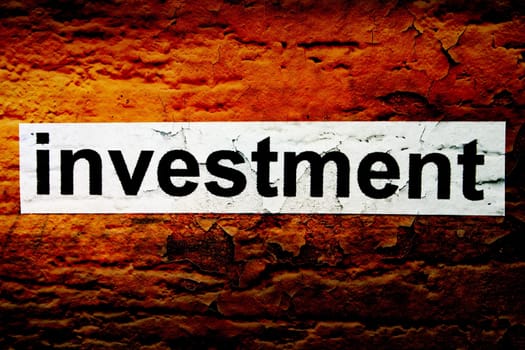 Investment text on grunge background