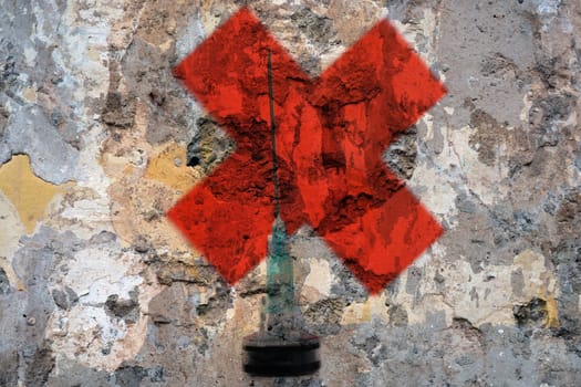 Syringe and red cross
