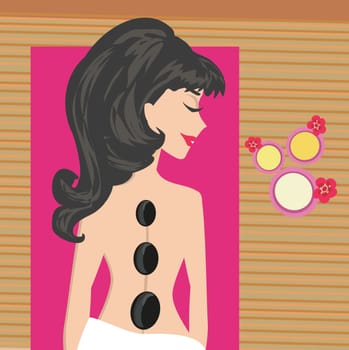 Woman getting hot stone massage in spa salon