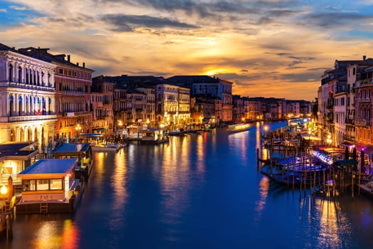 Beautiful night buildings in the Grand Canal in twilight, view from Rialto Bridge, Venice, Italy.