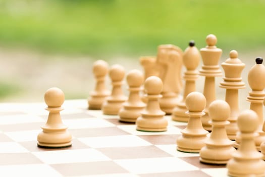 The white pawn chess piece is starting the match on the chessboard.
