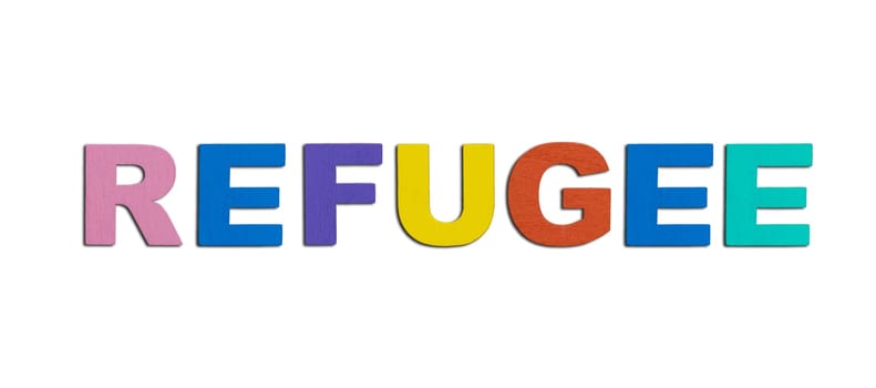 Refugees, word written in colorful wooden alphabet letters isolated. Safe migration for people escaping from war, support and assistance concept. Top view. Copy space
