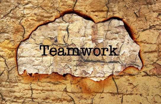 Teamwork text on paper hole