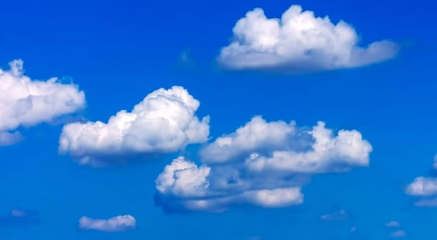 Blue sky and white puffy clouds.