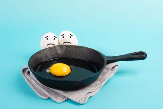 A fried egg in a pan, two friends look with sad faces at him, having a breakfast in the morning, funny food, broken friendship, healthy food