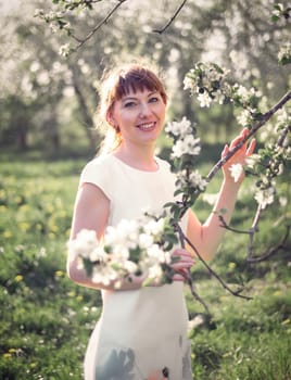 Young woman portrait on blooming apple trees background