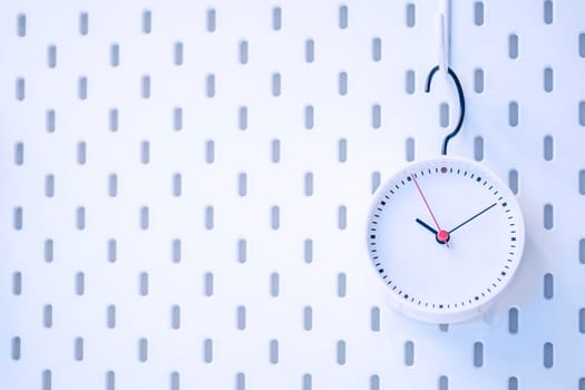 Closeup blue wall clock set on blue background