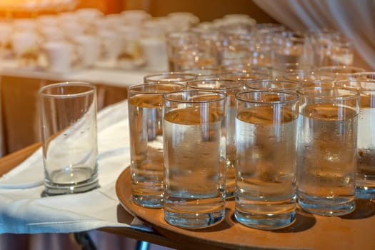 Many glasses of water on bar counter