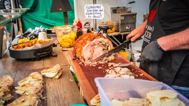 Hockenheim, Germany - May 28, 2022: Street food festival, preparing local meat delicacy at food truck