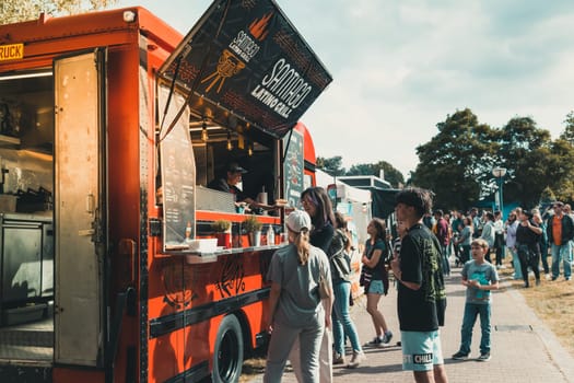 Hockenheim, Germany - May 28, 2022: Street food festival with food trucks and people ordering international street food and fancy food