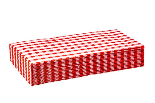 Closeup of a stack of red checked or checkered paper napkins isolated on a white background. Clipping path. Macro. Stacked towel or tablecloth.
