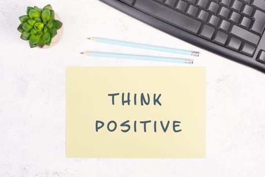 Think positive is standing on a paper, computer keyboard and a cactus, brainstorming for new ideas, new mindest, home office desk