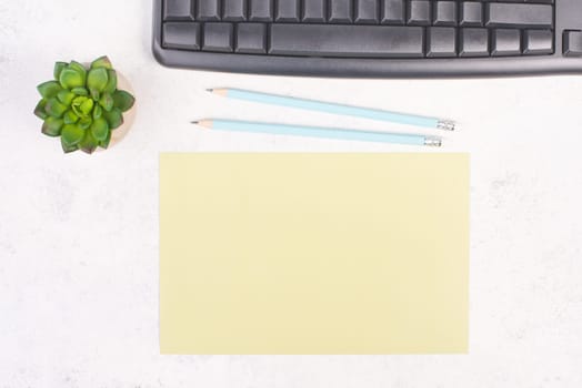 Empty paper with a pen, computer keyboard and a cactus, textured background, brainstorming for new ideas, writing a message, taking a break, home office desk