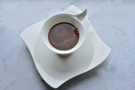 black coffee in a decorative white cup