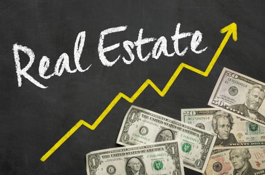 Text on blackboard with Dollars - Real Estate