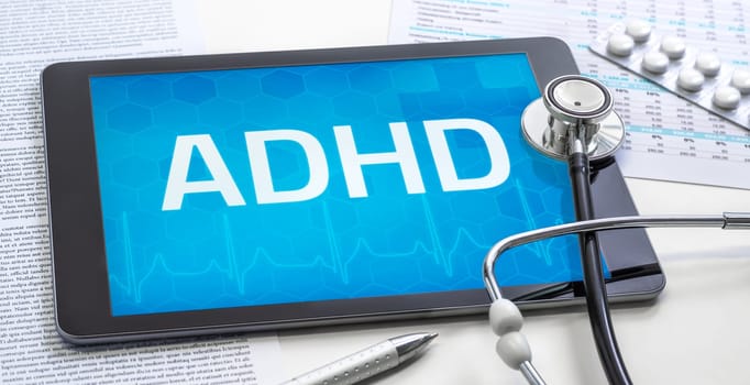 The word ADHD on the display of a tablet
