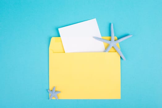 Blue colored summer and vacation background, sea star in an envelope, copy space for text, holiday and tourism concept