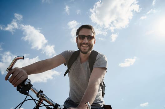 Man with bicycle having fun. Retro style image.