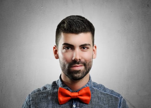 Portrait of young handsome man with red bowtie